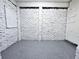 Spacious basement features white brick walls, painted gray floor, and pegboard at 2400 Glenrock Dr, Decatur, GA 30032