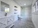 Modern bathroom with floating shelves, tiled floors, glass shower door and natural light at 2400 Glenrock Dr, Decatur, GA 30032