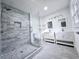 Modern bathroom with marble tiled shower, double vanity and sleek finishes at 2400 Glenrock Dr, Decatur, GA 30032