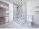 Bathroom features a glass shower, tile flooring, and white fixtures at 2400 Glenrock Dr, Decatur, GA 30032