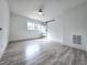 Bedroom features wood-look floors, a ceiling fan, and a modern sliding barn door at 2400 Glenrock Dr, Decatur, GA 30032