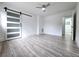 Bedroom features wood-look floors and a modern sliding barn door at 2400 Glenrock Dr, Decatur, GA 30032