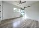 Bright bedroom featuring wood-look floors, a ceiling fan, and a modern sliding barn door at 2400 Glenrock Dr, Decatur, GA 30032