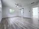 Bedroom features wood-look floors, a ceiling fan, and a modern sliding barn door at 2400 Glenrock Dr, Decatur, GA 30032