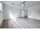 Open bedroom with wood-look floors, a ceiling fan and multiple doors for accessibility at 2400 Glenrock Dr, Decatur, GA 30032