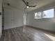 Bright bedroom featuring wood-look floors, a ceiling fan, and a large window at 2400 Glenrock Dr, Decatur, GA 30032