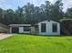 Charming renovated home with a freshly painted white brick exterior, dark trim, and a well-maintained green lawn at 2400 Glenrock Dr, Decatur, GA 30032