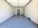 Spacious garage with gray epoxy floor, white walls, and doorway to another room at 2400 Glenrock Dr, Decatur, GA 30032
