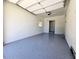 Bright garage with white walls and gray speckled floor, featuring a doorway to another room at 2400 Glenrock Dr, Decatur, GA 30032