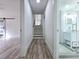Hallway view, highlighting hardwood floors, and a barn door with shower room entrance at 2400 Glenrock Dr, Decatur, GA 30032