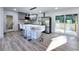 Modern kitchen with new stainless steel appliances, kitchen island and a sliding glass door leading to a deck at 2400 Glenrock Dr, Decatur, GA 30032