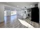 Bright, open layout with gray floors, seamlessly connecting the living area, kitchen with island, and deck access at 2400 Glenrock Dr, Decatur, GA 30032