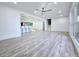 Open concept living room with view of the kitchen and access to the stairwell that goes to the upper and lower levels at 2400 Glenrock Dr, Decatur, GA 30032
