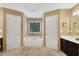 Bathroom with soaking tub, tile floor, and dual vanities at 260 Roberts Rd, Suwanee, GA 30024