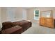 Cozy bedroom with neutral walls, carpet, wooden furniture and natural light from window with backyard view at 260 Roberts Rd, Suwanee, GA 30024