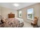 Sunlit bedroom with carpet, soft color scheme, chair, and a window that offers views of the landscaped yard at 260 Roberts Rd, Suwanee, GA 30024