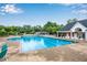 A large community swimming pool with plenty of lounge chairs and shade at 260 Roberts Rd, Suwanee, GA 30024