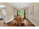 Formal dining room with hardwood floors, chandelier, and view into the adjacent kitchen at 260 Roberts Rd, Suwanee, GA 30024