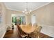 Elegant dining room featuring hardwood floors, chandelier, and view into the next room at 260 Roberts Rd, Suwanee, GA 30024