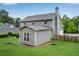 Backyard of the home showing the deck and outdoor space, bordered by trees and manicured lawn at 260 Roberts Rd, Suwanee, GA 30024