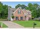 Brick two-story home with attached garage and lush green lawn in a suburban setting at 260 Roberts Rd, Suwanee, GA 30024