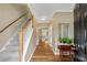 Inviting foyer with hardwood floors, staircase, and view into the adjacent kitchen area at 260 Roberts Rd, Suwanee, GA 30024