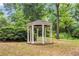 Charming white gazebo with a black roof surrounded by lush greenery and trees at 260 Roberts Rd, Suwanee, GA 30024