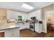 Bright kitchen with white cabinets, stainless steel appliances, and granite countertops at 260 Roberts Rd, Suwanee, GA 30024