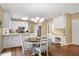 Bright eat-in kitchen features white cabinets, stainless appliances, and adjacent dining area at 260 Roberts Rd, Suwanee, GA 30024