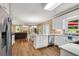 Open kitchen with white cabinets, stainless appliances and a view into the living room at 260 Roberts Rd, Suwanee, GA 30024