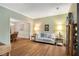 Comfortable living room with hardwood floors and neutral-toned walls leading to dining area at 260 Roberts Rd, Suwanee, GA 30024