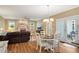 Open-concept living room and dining area with hardwood floors and access to the backyard at 260 Roberts Rd, Suwanee, GA 30024