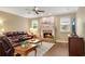 Comfortable living room featuring a brick fireplace, hardwood floors, and a cozy leather sofa at 260 Roberts Rd, Suwanee, GA 30024