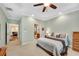 Large primary suite featuring a tray ceiling, neutral paint, and adjoining bathroom at 260 Roberts Rd, Suwanee, GA 30024