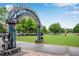 Public art installment made of trophies and electronics on a park lawn under a blue sky at 260 Roberts Rd, Suwanee, GA 30024