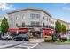 Three-story gray building with red awnings and outdoor seating at the Tequila Mama Taqueria restaurant at 260 Roberts Rd, Suwanee, GA 30024