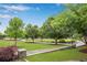 Lush green town green with walking paths, landscaping and shade trees at 260 Roberts Rd, Suwanee, GA 30024