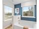 Well lit bathroom showcasing a garden tub with wall to wall windows at 520 Amethyst Way, Stockbridge, GA 30281