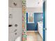 Well-lit bathroom showcasing a shower with a colorful curtain and modern vanity with ample storage at 520 Amethyst Way, Stockbridge, GA 30281