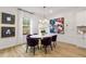 Inviting dining room features a modern table with purple chairs, stylish lighting and a large window at 520 Amethyst Way, Stockbridge, GA 30281