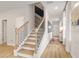 Inviting foyer with hardwood floors, stairs, stylish console table, and elegant decorations at 520 Amethyst Way, Stockbridge, GA 30281