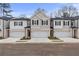 Modern townhome exterior with a two-car garage, neutral color palette, and professionally landscaped front yard at 520 Amethyst Way, Stockbridge, GA 30281