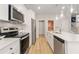 Modern kitchen featuring stainless steel appliances, white cabinets and an island with countertop seating at 520 Amethyst Way, Stockbridge, GA 30281