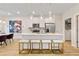 Bright kitchen featuring white cabinetry, stainless steel appliances, and an island with bar seating and pendant lighting at 520 Amethyst Way, Stockbridge, GA 30281
