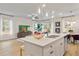 Open concept kitchen and living room with a white island and modern stainless steel appliances at 520 Amethyst Way, Stockbridge, GA 30281