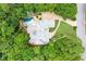 Aerial view showcases grand estate with pool, manicured lawns, and a circular driveway at 8957 Old Southwick Pass, Johns Creek, GA 30022