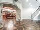 The basement features a stone archway leading to a game room with a pool table and a bar at 8957 Old Southwick Pass, Johns Creek, GA 30022