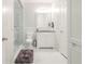 Modern bathroom with a glass enclosed shower and white cabinets and countertops at 8957 Old Southwick Pass, Johns Creek, GA 30022