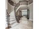 Elegant foyer showcasing a grand staircase, marble floors, and intricate doorway details leading to the living room at 8957 Old Southwick Pass, Johns Creek, GA 30022