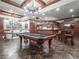 Basement game room with a pool table, bar area, and plenty of space for entertaining at 8957 Old Southwick Pass, Johns Creek, GA 30022